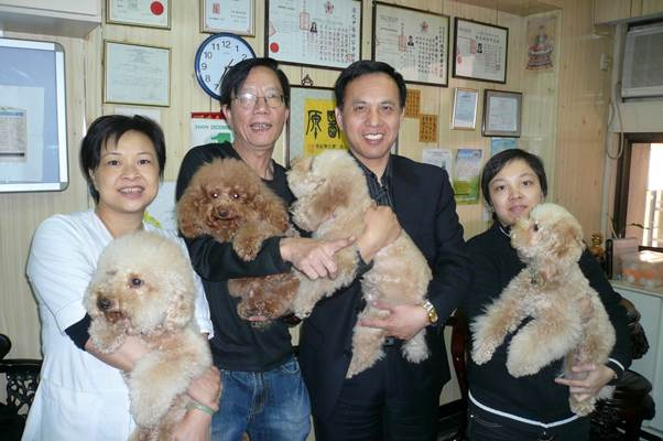 黃元璋及夫人和女兒，我們各抱一隻小狗，展現欣喜心情 